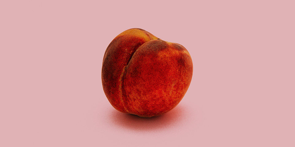 peach sitting on pink background