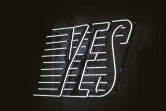 White Neon "Yes" with lines on black background