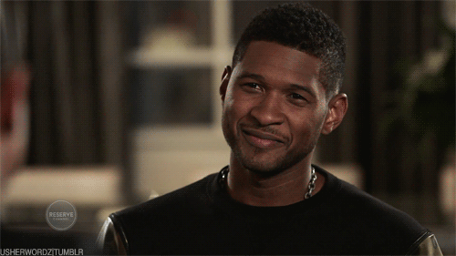 Usher smiles at interviewer off camera